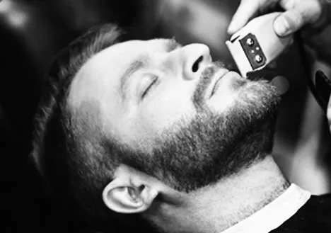 Man receiving a beard trim